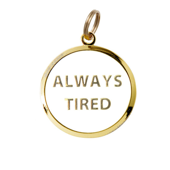 always tired white and gold enamel pet id tag on black packaging card trill paws